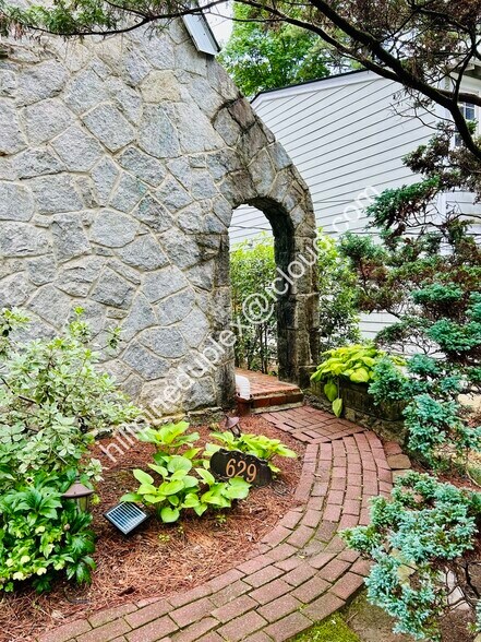 Private entrance with walkway from parking pad. - 629 Hillpine Dr NE