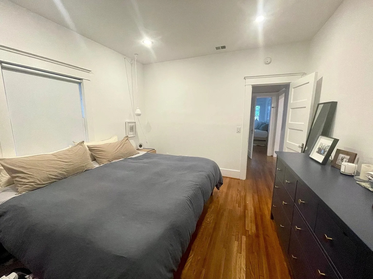 Primary bedroom with full-size closet storage and soft natural light. - 6000 Carlton Way