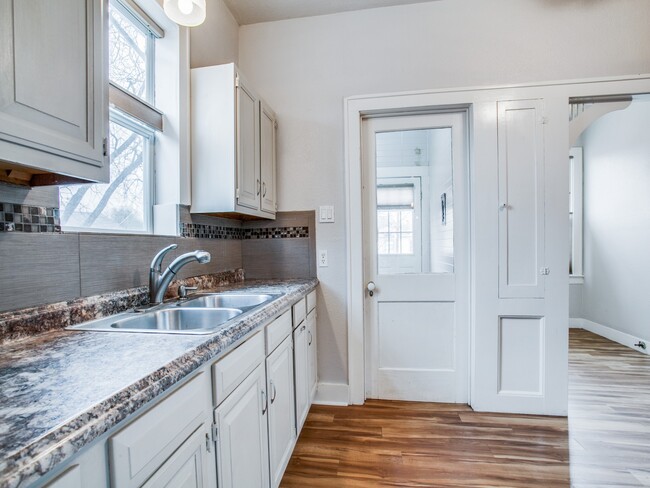 Kitchen leading to backdoor and laundry area. - 1007 W Craig Pl