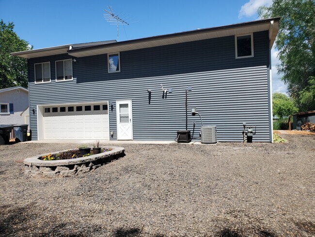 Front of house from street. Up to 5 cars can fit in the driveway. Street parking should be limited. - 18629 Langly Ave N