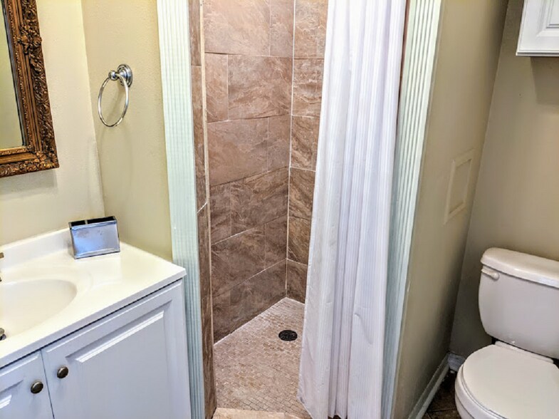 bathroom w/shower, vanity and toilet. - 2350 1st Ave N