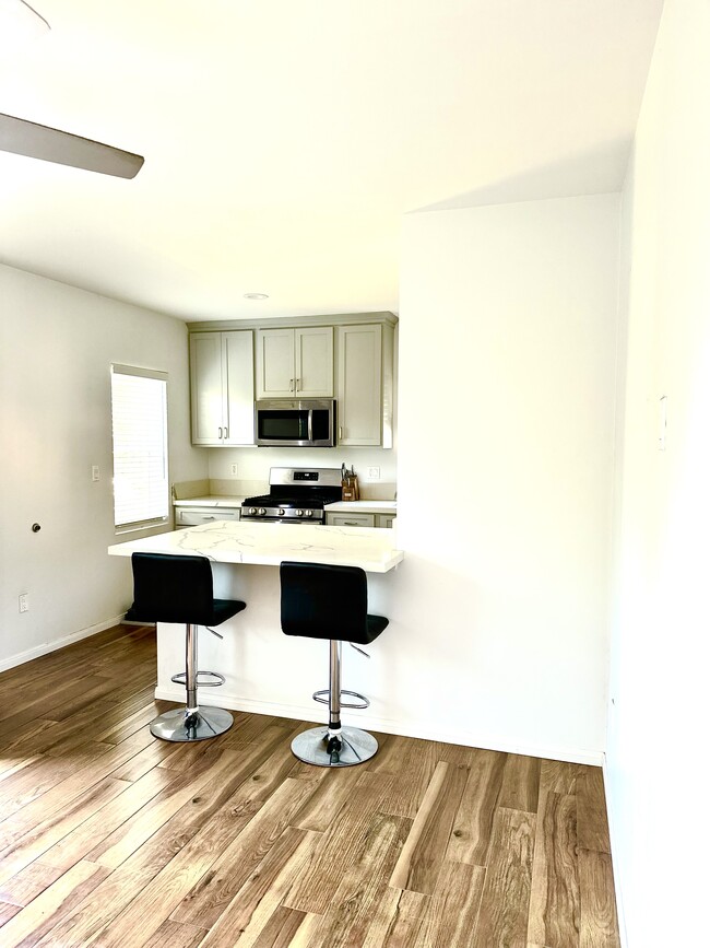 Open concept kitchen and island connected to living room - 3163 Helms Ave