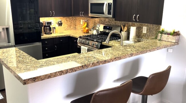 Kitchen and breakfast bar. - 7712 Himalayas Ave