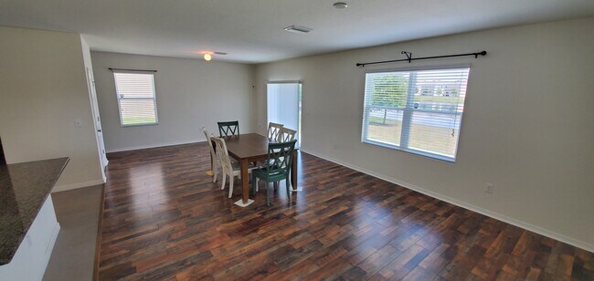 Sliding doors in dining area lead to backyard patio with a view - 7583 Tuscan Bay Cir