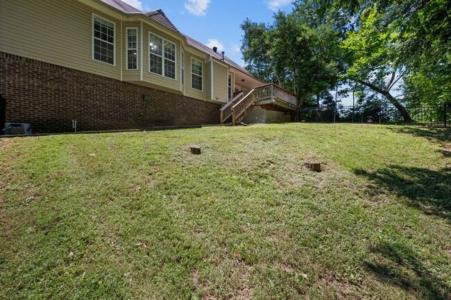 Building Photo - Stunning Stone Fireplace • Finished Basement • Fenced Yard