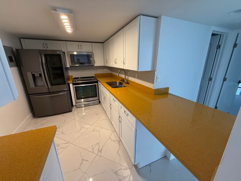 Open-concept KITCHEN w limited edition custom quartz countertops - 780 NE 69th St