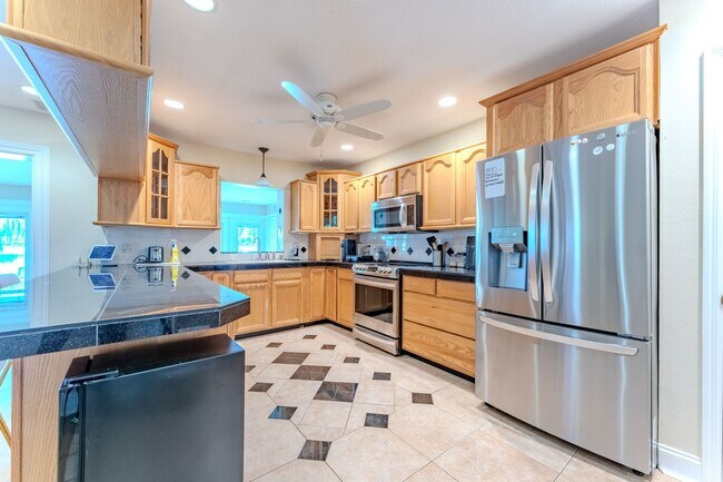 Building Photo - Lake Jessamine Luxury: Solar-Powered Waterfront Retreat on 1.14 Acres with Dock & Boathouse