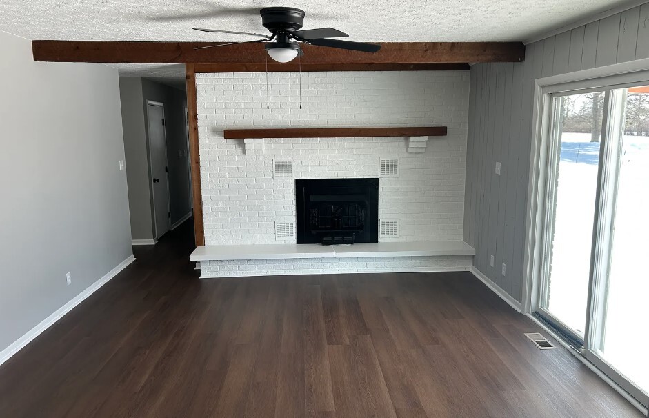 Fireplace in den. New fixture. Sliding door to back covered porch. - 2751 Hart Rd