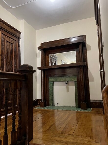 Stairs to second floor front hallway and front door - 32 W Alvord St