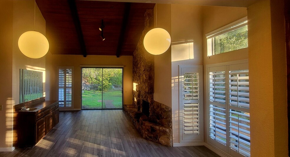 Family room with stone fireplace and wet bar - 16139 Ladera Piedra Way