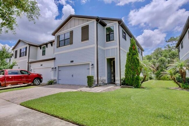 Building Photo - Beautiful 4/3.5 Townhome with a Spacious 2 Car Garage Located in Trails at Moss Park - Orlando