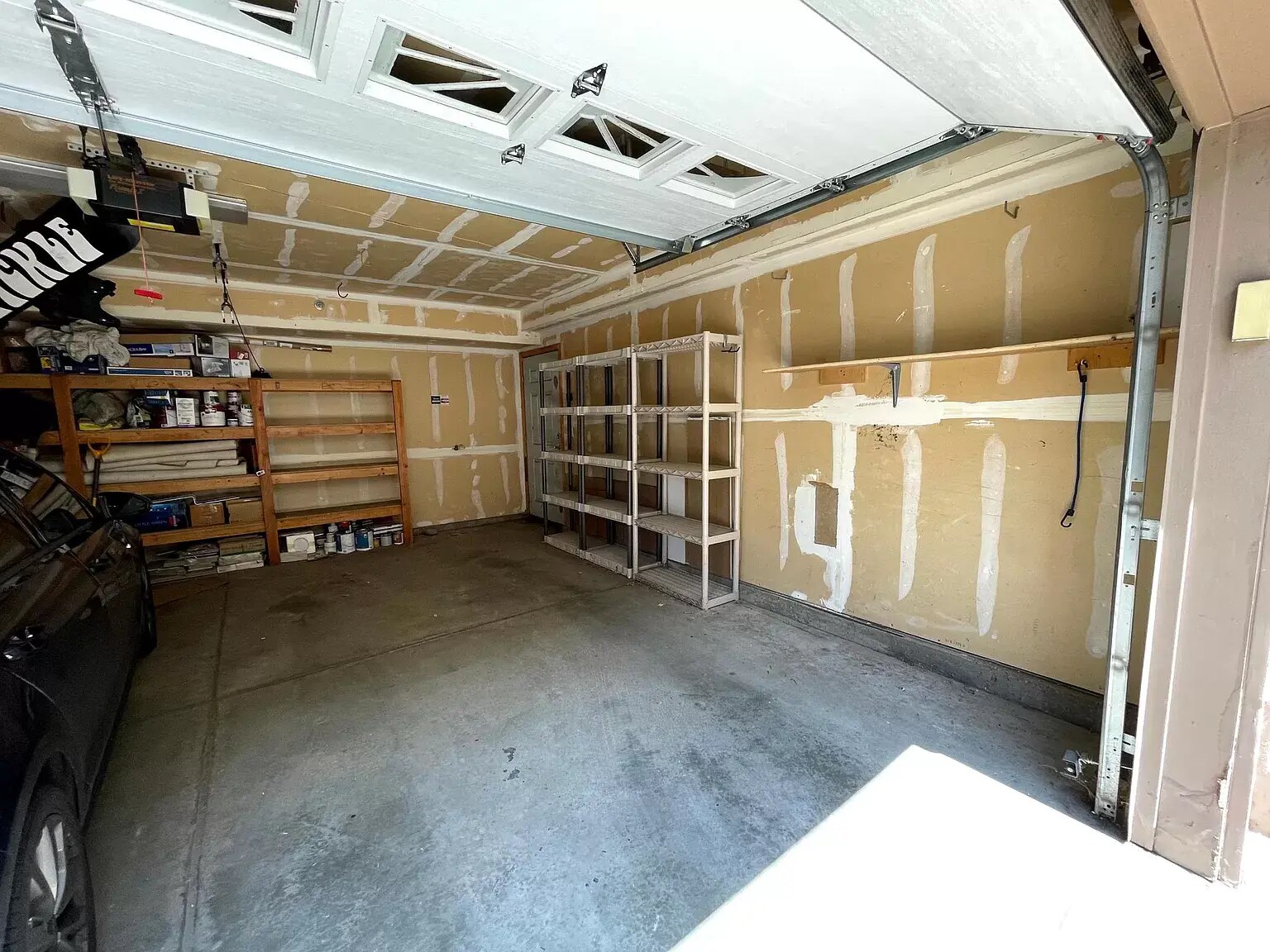 Full size garage spot in the shared garage. Plenty of storage on the side wall, back wall, ski hook. - 1641 N Washington St