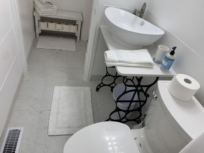 Marble floors and baseboards in bathroom. - 322 E 19th St