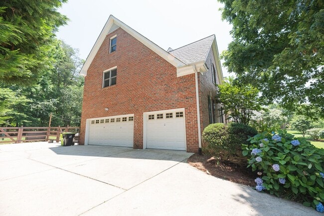 Building Photo - Spacious & Striking 3-story brick Executive 4 bedroom 4.5 bathroom home in Oak Ridge NC + Lawn ca...