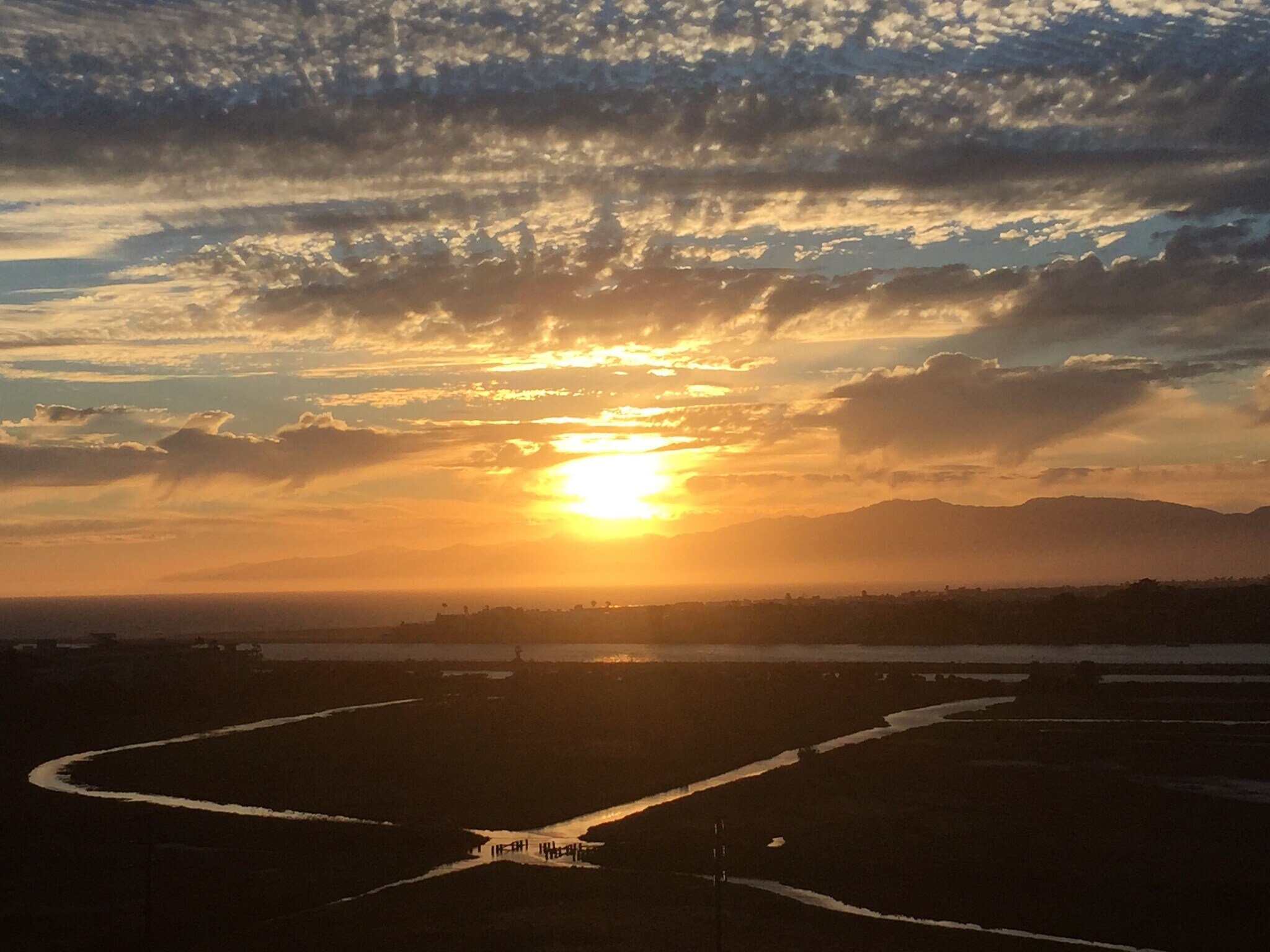 Enchanting sunset views stretch across the coastline, where golden light dances on the ocean - 8120 Billowvista Dr