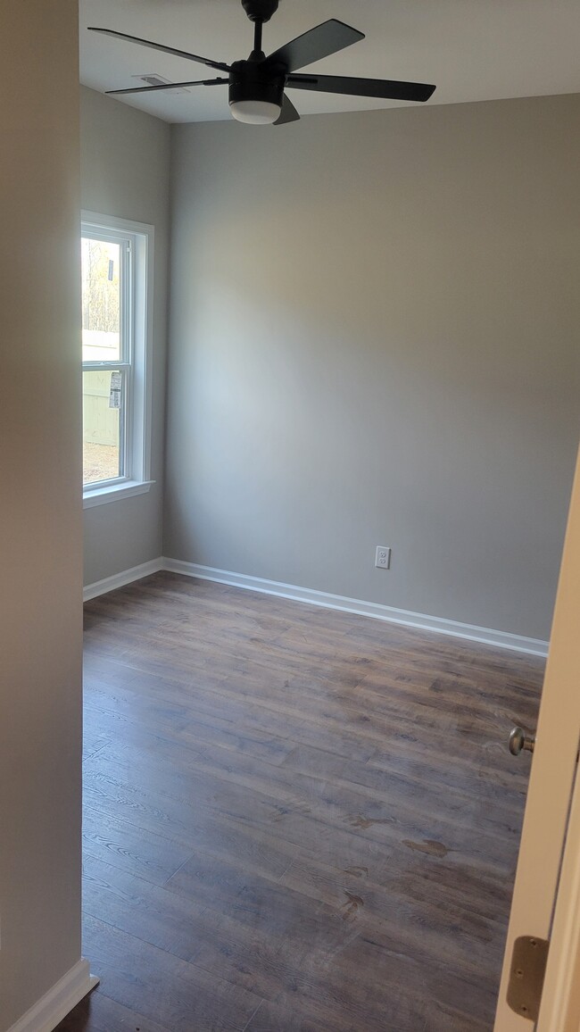 Bedroom 2 with laminate floors and ceiling fan - 203 Payne St