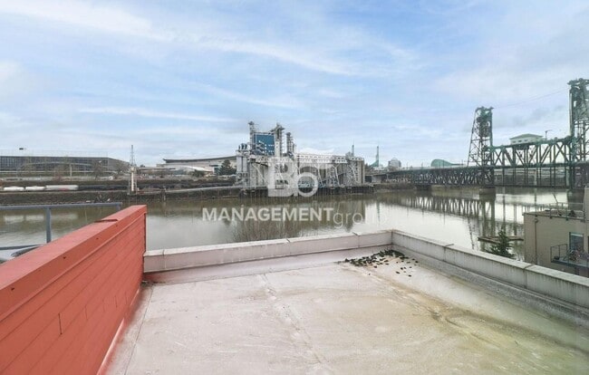 Building Photo - Spacious Riverfront Condo- Beautiful Condo w/River View from Bedroom! Parking Included!