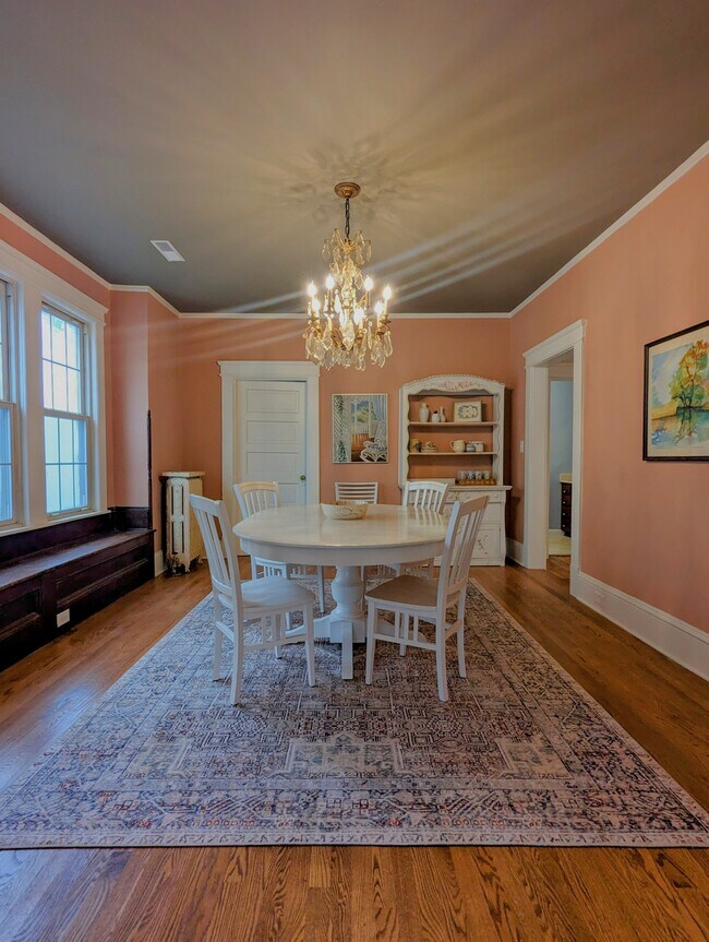 Dining room with hardwood floors, chandelier, window seat, coat closet - 7216 W Clinton Ave