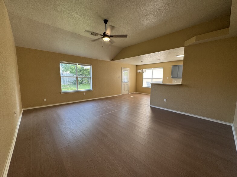 Vaulted ceiling and a wide picture window fill the great room with natural light while keeping sight - 2806 Maria Dr