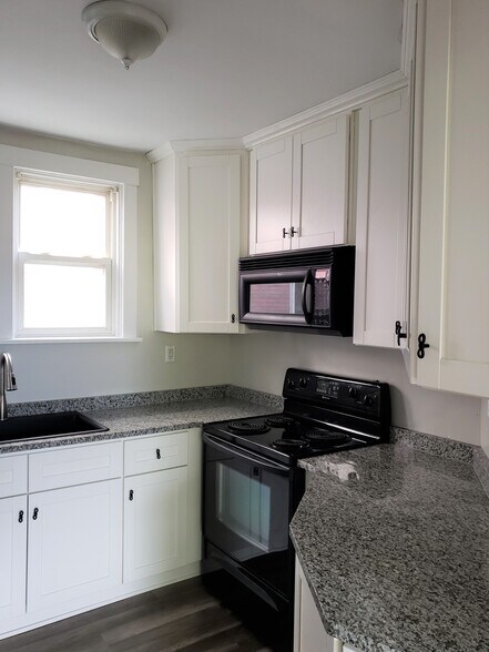 Granite countertops and stylish cabinetry with lots of storage. - 201 Richbarn Rd