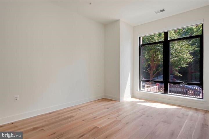 Large bedroom with custom shades. - 801 N St NW