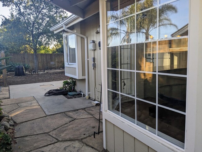 walking past the dining nook in the side yard - 4025 Via Diego