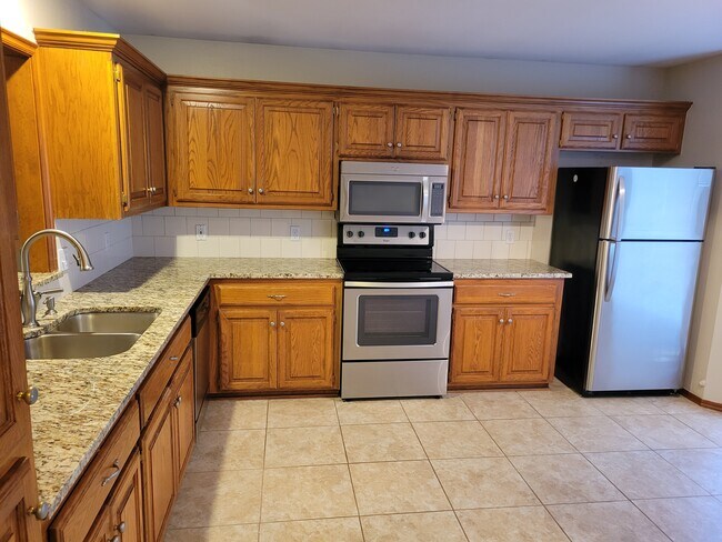 Granite in the kitchen with updated appliances - 921 Blue Ridge Dr