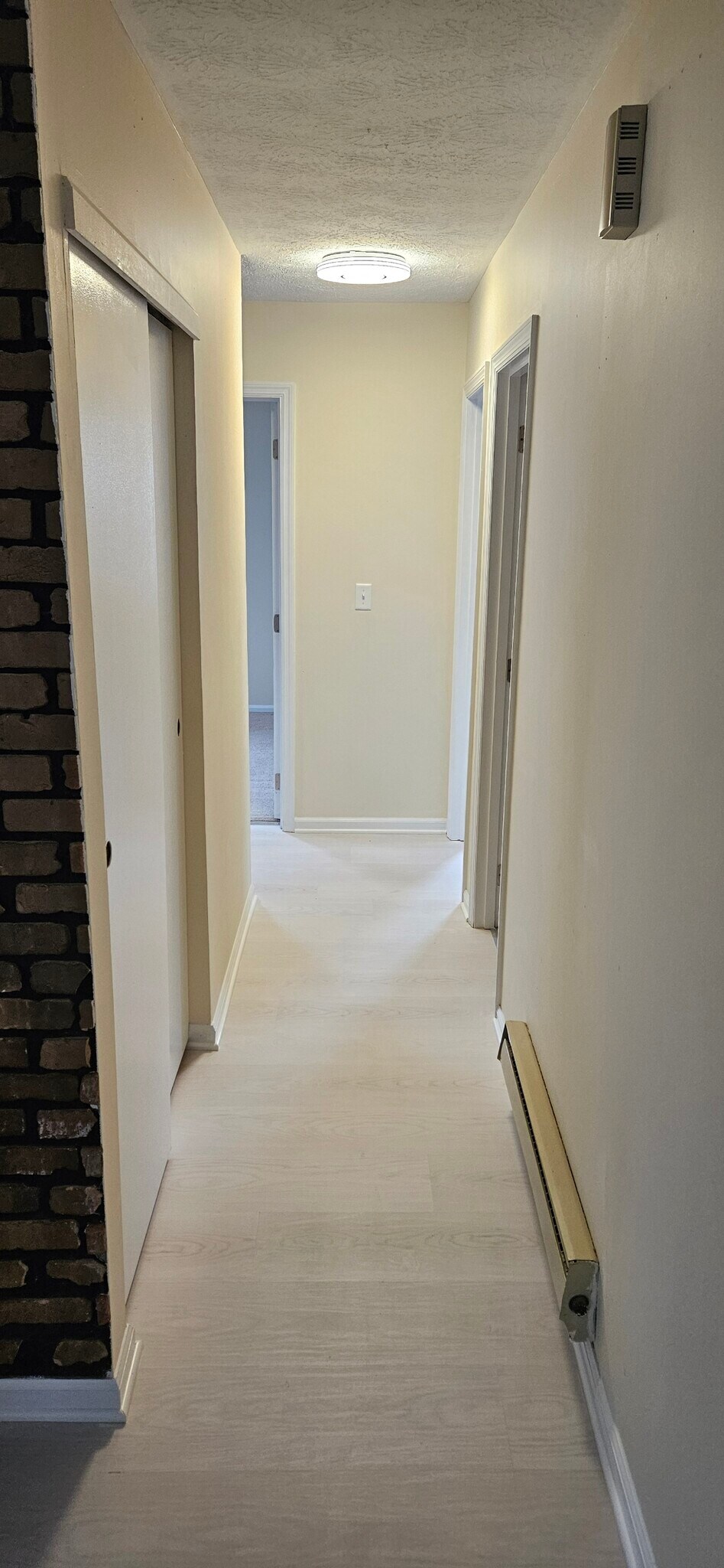 Hallway with coat closet on left and full bathroom on right. - 578 Tyler St