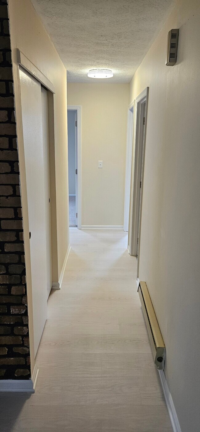 Hallway with coat closet on left and full bathroom on right. - 578 Tyler St