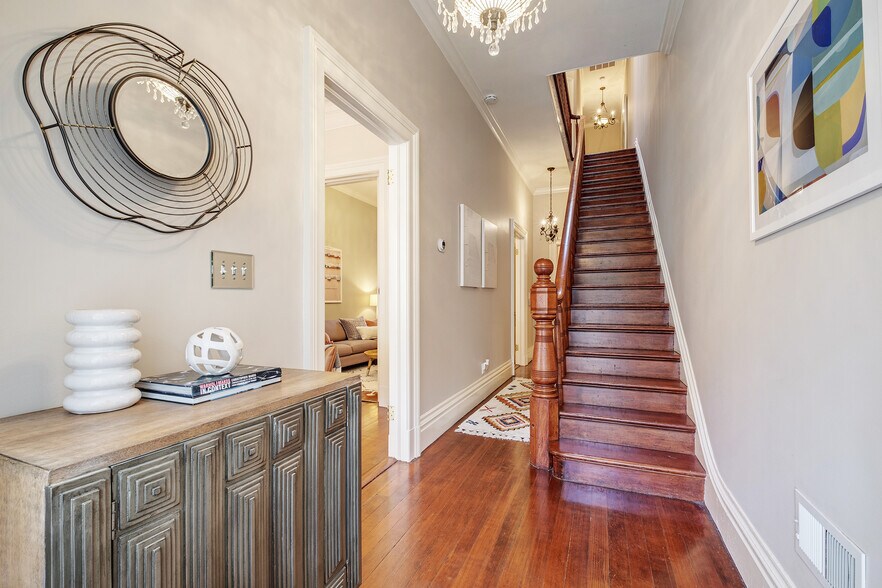 Entry with gleaming original Douglas Fir floors and carved stairs - 2188 Sutter St