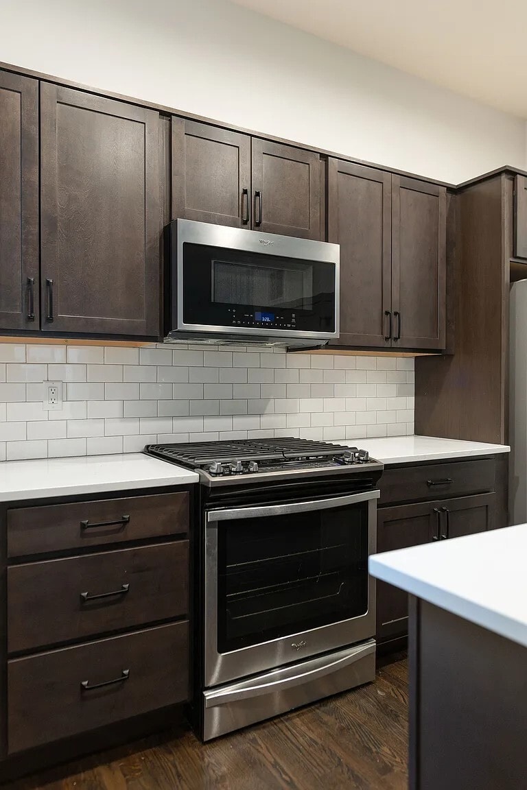 Full kitchen with stainless steel appliances, including a microwave, gas range, dishwasher, & fridge - 3505 S Marion St