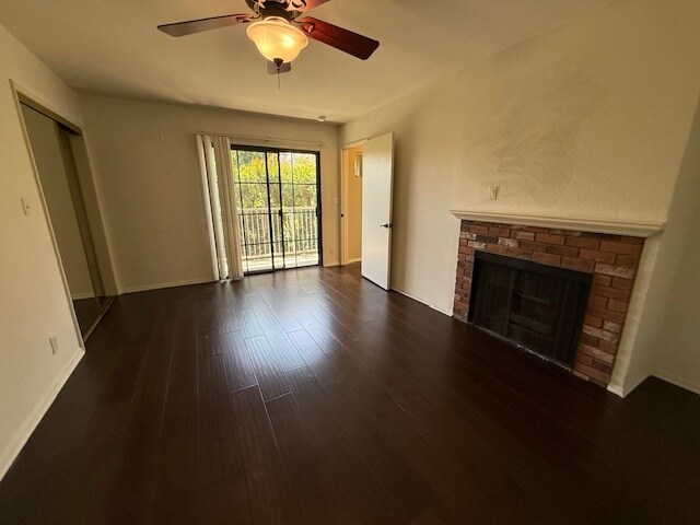Large front bedroom with faux fireplace, hardwood floors and balcony - 10481 Riverside Dr