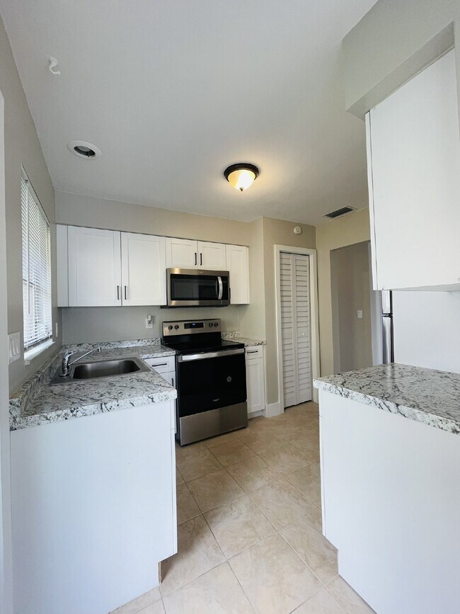 Building Photo - Updated 2-bedroom waterfront duplex with walk-in closets, enclosed Florida room, and canal views ...