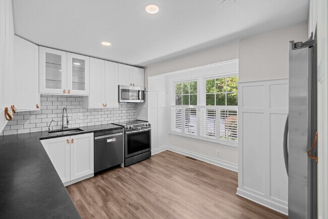Building Photo - Completely Renovated Corner Townhome with Modern Kitchen, Designer Baths, and Private Yard