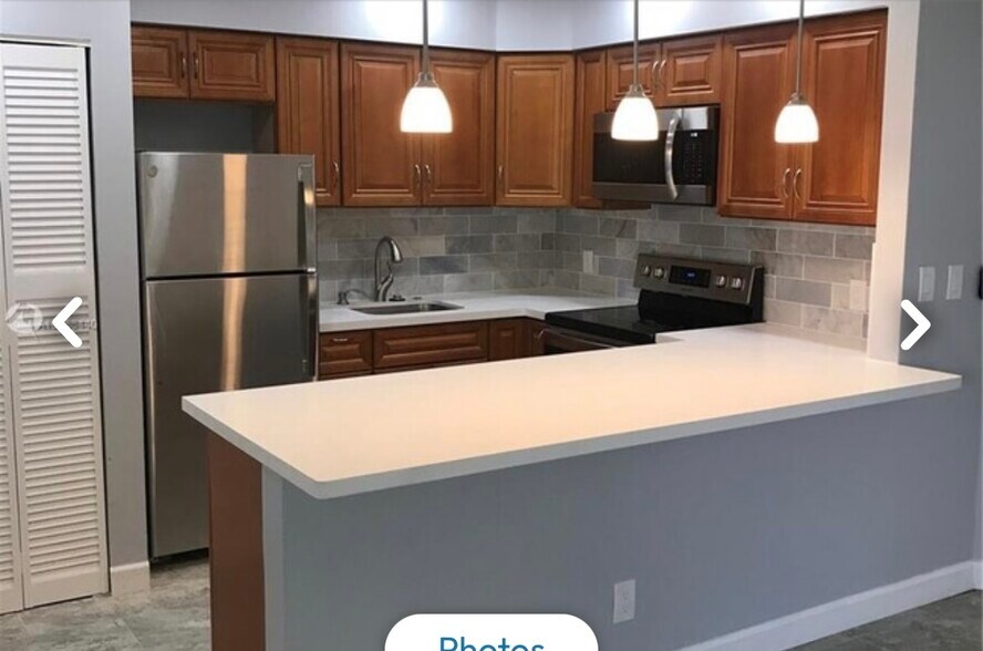 Newer kitchen cabinets & quartz lighting over breakfast bar - 3049 NE 20th Ter