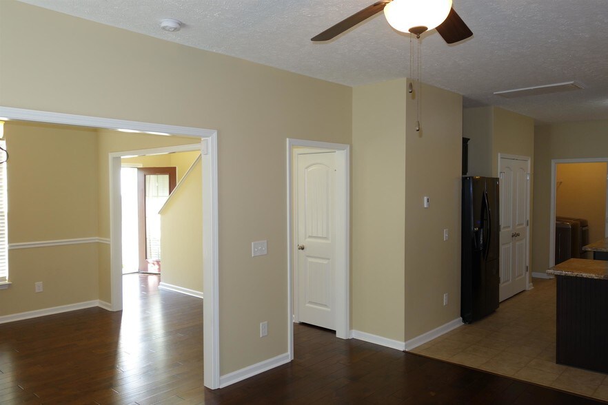 Standing in living room, facing the front of the home, you see half bath door, open to dining room or convert to an office and stairway near front door - 104 Read Tavern Rd