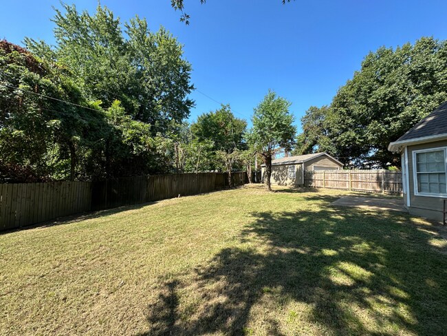 Building Photo - Charming 3BR/2BA Near Southwind | Hardwood Floors, Brick Fireplace, Bay Window & 2-Car Garage