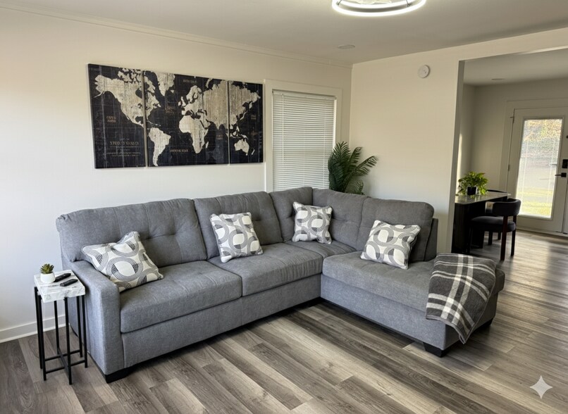 A cozy family room with a comfortable sofa and a large TV—perfect for relaxing, streaming your favor - 2394 Bouldercliff Way SE