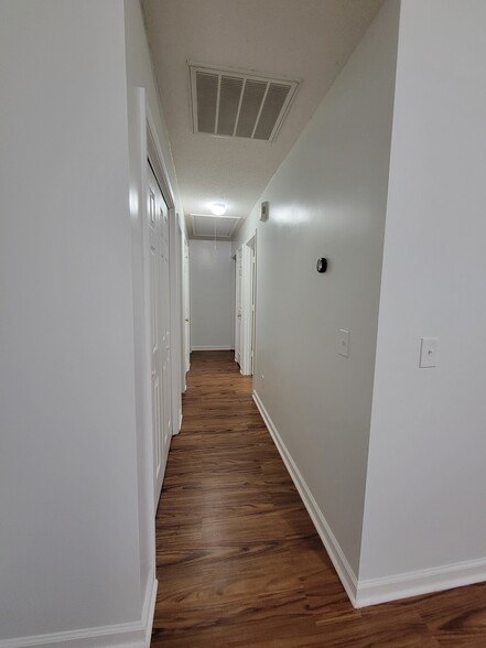 Hallway provides 3 spacious closets for added storage space. Smart thermostat controls - 103 Pasofina Dr