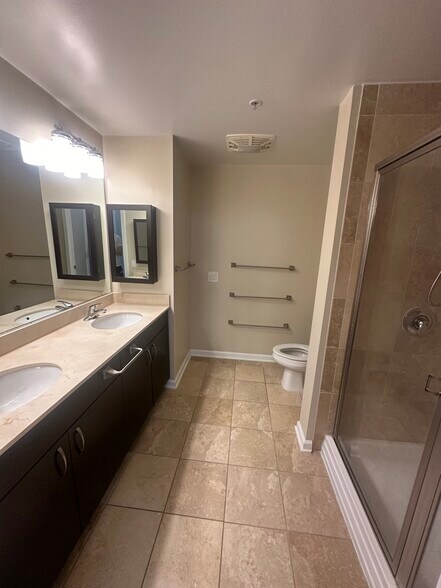 Ignore (other half) - Primary bathroom, double vanity with medicine cabinets.. - 440 L St NW