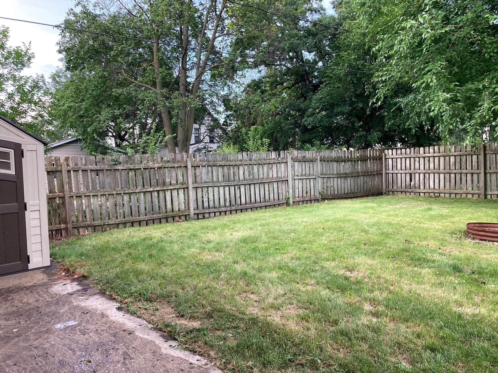 fenced back yard with fire pit - 1111 Sorin St