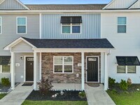 Building Photo - Available Now! Enjoy low-maintenance coastal living in this beautiful 2-bedroom, 2.5-bath townhom...