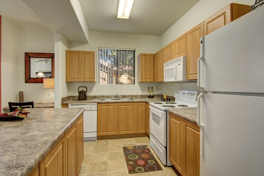 Arezzo Apartments- kitchen with white appliances and wooden cabinets - Arezzo