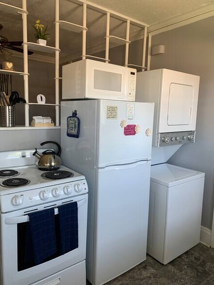 Kitchen: electric range, new refrigerator, washer/dryer, microwave, blender, toaster, coffee maker - 1411 Winburn Dr