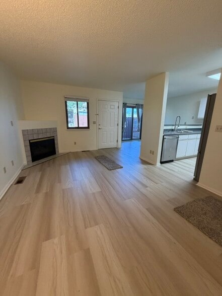 Family Room with New Flooring and Gas Fireplace Throughout - 18294 W 58th Pl