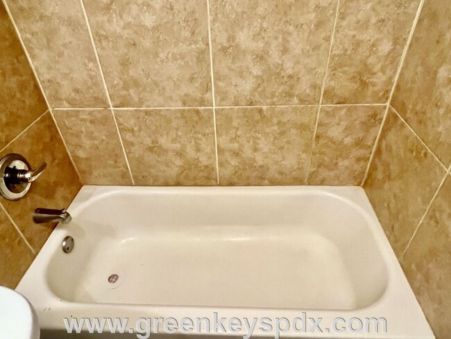 Building Photo - This 3-bedroom 1-bathroom house has a large front yard and a mostly fenced backyard.