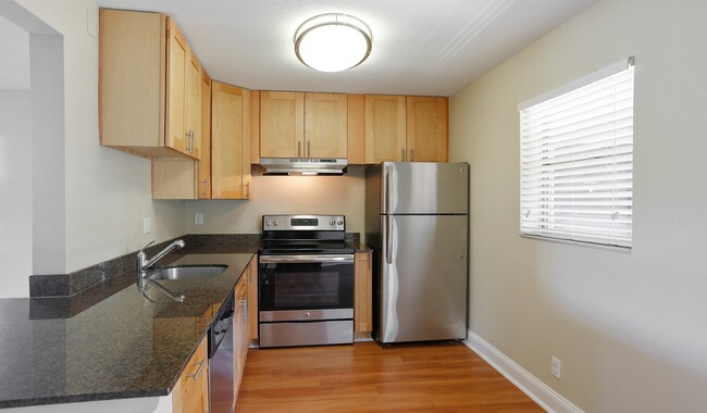 Enjoy upgraded kitchen cabinets and ample counter space - Plantation Gardens Apartment Homes