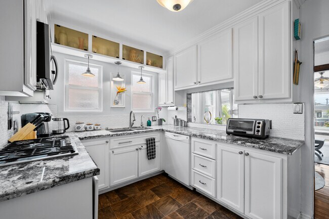 Upgraded kitchen with plenty of storage. - 1150 W 25th St