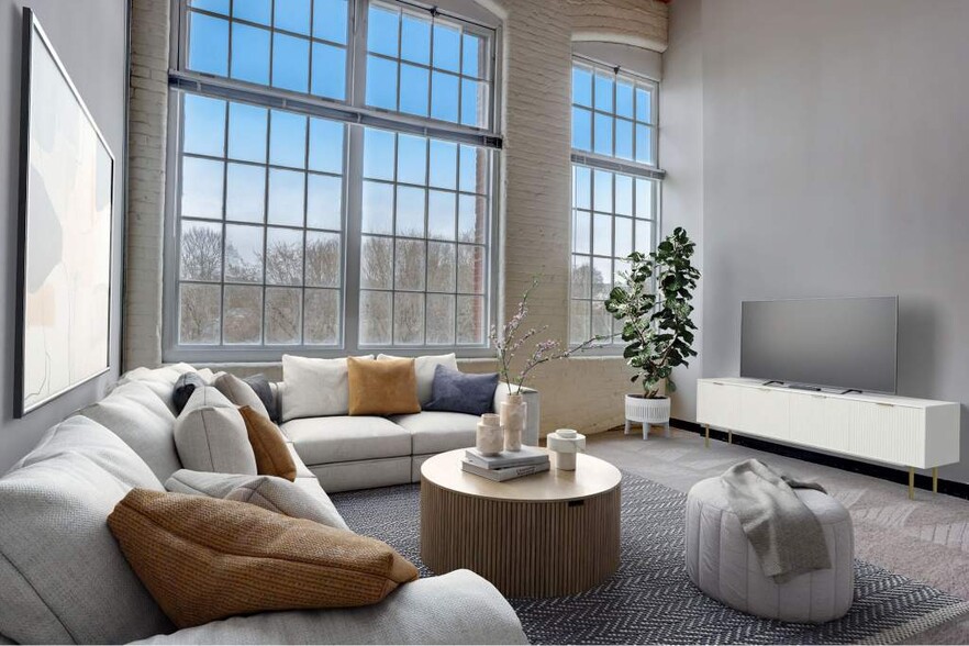 Living Room With Expansive Windows - Residences at Slatersville Mill