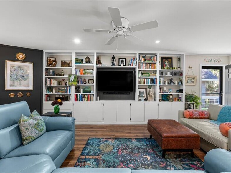 Living room filled with artwork and books. Lots of storage too - 1868 Tickton Hall Rd
